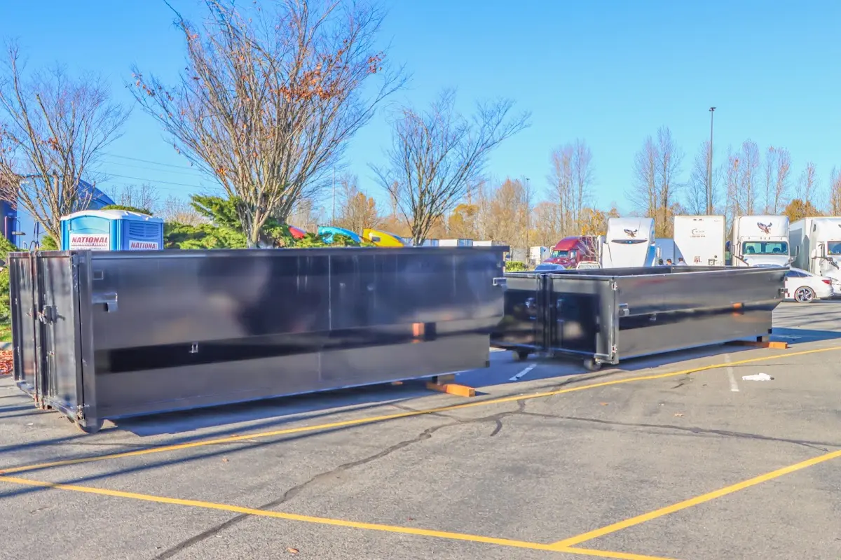 Professional dumpster rental service with roll-off container on residential driveway in Franklin Lakes